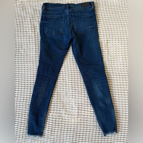Express dark wash skinny jeans with distressed bottoms. - Picture 3 of 4